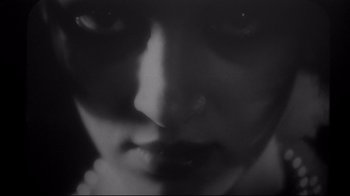 Movie still from “Henry & June” (1990), directed by Philip Kaufman – A black - and - white photo of a woman's face; Extreme Close Up shot, Overhead angle