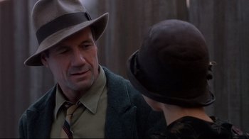 Movie still from “Henry & June” (1990), directed by Philip Kaufman – A man and a woman wearing hats talking to each other; Close Up shot, Over the shoulder angle