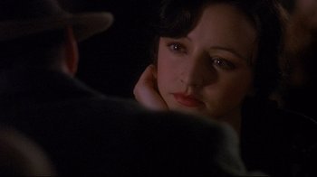 Movie still from “Henry & June” (1990), directed by Philip Kaufman – A person looking at the camera; Close Up shot, Over the shoulder angle