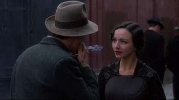 Movie still from “Henry & June” (1990), directed by Philip Kaufman – A man and a woman standing next to each other in front of a building; Close Up shot, Over the shoulder angle