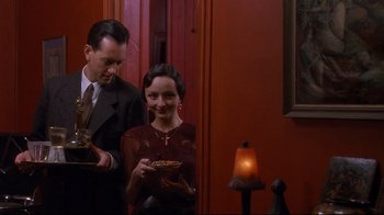 Movie still from “Henry & June” (1990), directed by Philip Kaufman – A man and a woman standing next to each other; Medium shot, High angle