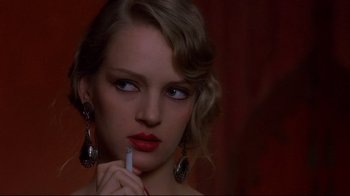 Movie still from “Henry & June” (1990), directed by Philip Kaufman – A beautiful woman holding a cigarette in her mouth; Close Up shot, Over the shoulder angle