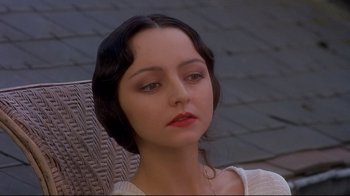 Movie still from “Henry & June” (1990), directed by Philip Kaufman – A young woman with red lipstick sitting in a chair; Close Up shot, High angle
