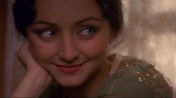Movie still from “Henry & June” (1990), directed by Philip Kaufman – A woman's face with her hand on her chin; Close Up shot, Over the shoulder angle