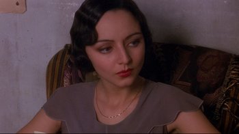 Movie still from “Henry & June” (1990), directed by Philip Kaufman – A person sitting on a chair; Close Up shot, High angle