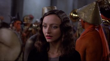 Movie still from “Henry & June” (1990), directed by Philip Kaufman – A woman with long brown hair wearing a black jacket; Close Up shot, Over the shoulder angle