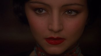 Movie still from “Henry & June” (1990), directed by Philip Kaufman – A woman's face with red lipstick; Close Up shot, Over the shoulder angle