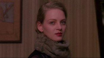 Movie still from “Henry & June” (1990), directed by Philip Kaufman – A woman wearing a scarf and a leather jacket; Close Up shot, Over the shoulder angle