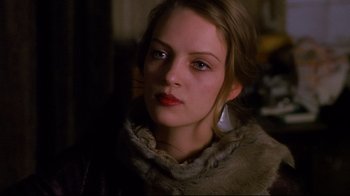 Movie still from “Henry & June” (1990), directed by Philip Kaufman – A young woman wearing a fur coat looking at the camera; Close Up shot, Over the shoulder angle