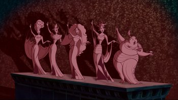 Movie still from “Hercules” (1997), directed by Ron Clements – A group of animated women standing next to each other on a stage; Wide shot, Low angle