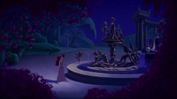 Movie still from “Hercules” (1997), directed by Ron Clements – A woman standing in front of a fountain at night; Extreme Wide shot, High angle