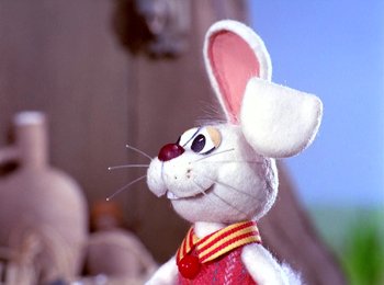 Movie still from “Here Comes Peter Cottontail” (1971), directed by Jules Bass – A stuffed bunny rabbit is wearing a red shirt; Close Up shot, Low angle