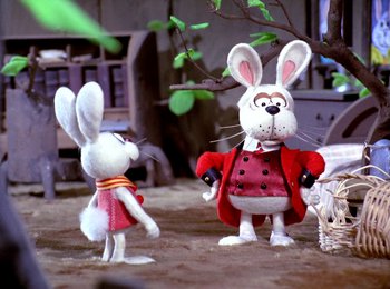 Movie still from “Here Comes Peter Cottontail” (1971), directed by Jules Bass – A couple of stuffed animals that are next to each other; Medium shot, Low angle