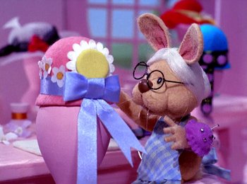 Movie still from “Here Comes Peter Cottontail” (1971), directed by Jules Bass – A stuffed bunny rabbit with glasses and a bow tie; Close Up shot, Low angle