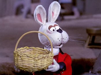 Movie still from “Here Comes Peter Cottontail” (1971), directed by Jules Bass – A rabbit holding a basket in front of him; Close Up shot, High angle