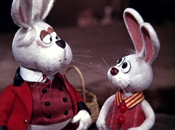 Movie still from “Here Comes Peter Cottontail” (1971), directed by Jules Bass – A couple of stuffed animals that are next to each other; Close Up shot, Over the shoulder angle