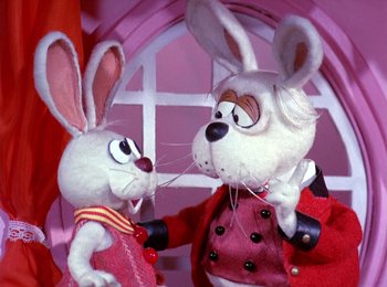 Movie still from “Here Comes Peter Cottontail” (1971), directed by Jules Bass – A couple of stuffed animals that are next to each other; Close Up shot, Over the shoulder angle