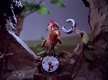 Movie still from “Here Comes Peter Cottontail” (1971), directed by Jules Bass – A toy chicken sitting on top of an alarm clock; Extreme Close Up shot, Low angle