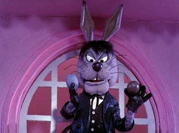 Movie still from “Here Comes Peter Cottontail” (1971), directed by Jules Bass – A character in a suit and bunny ears; Medium shot, Low angle