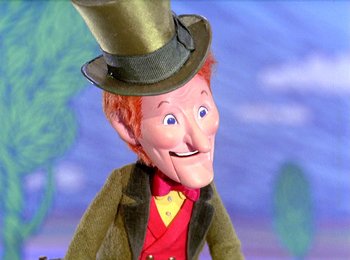 Movie still from “Here Comes Peter Cottontail” (1971), directed by Jules Bass – The head of a doll wearing a top hat; Close Up shot, Low angle