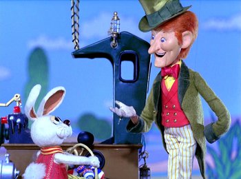 Movie still from “Here Comes Peter Cottontail” (1971), directed by Jules Bass – A man and a rabbit are standing next to each other; Medium shot, Low angle