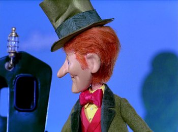 Movie still from “Here Comes Peter Cottontail” (1971), directed by Jules Bass – The head of a doll wearing a top hat; Close Up shot, Low angle