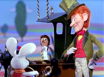 Movie still from “Here Comes Peter Cottontail” (1971), directed by Jules Bass – A doll and a stuffed animal on a table; Medium shot, Over the shoulder angle