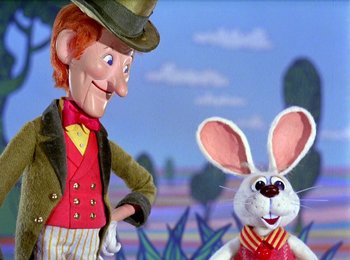 Movie still from “Here Comes Peter Cottontail” (1971), directed by Jules Bass – A rabbit next to a man in a suit; Medium shot, Low angle