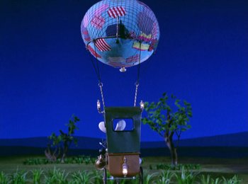 Movie still from “Here Comes Peter Cottontail” (1971), directed by Jules Bass – A hot air balloon is flying through the sky; Extreme Wide shot, Low angle
