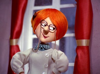 Movie still from “Here Comes Peter Cottontail” (1971), directed by Jules Bass – A red haired doll with a nose ring and glasses; Close Up shot, Low angle