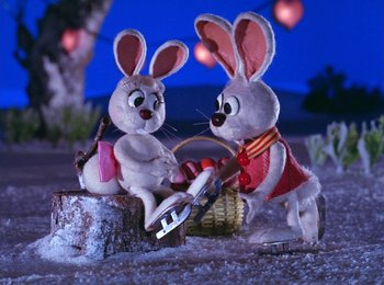 Movie still from “Here Comes Peter Cottontail” (1971), directed by Jules Bass – A couple of stuffed animals sitting next to each other; Medium shot, High angle