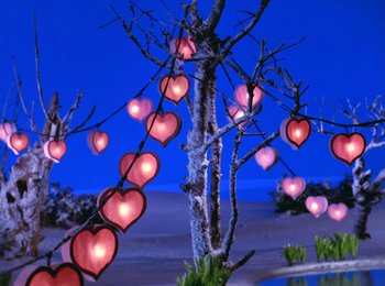 Movie still from “Here Comes Peter Cottontail” (1971), directed by Jules Bass – Hearts hanging from a tree in the night sky; Extreme Wide shot, High angle