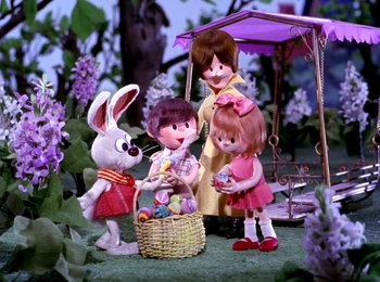 Movie still from “Here Comes Peter Cottontail” (1971), directed by Jules Bass – A group of children and an easter bunny in a field; Medium shot, High angle