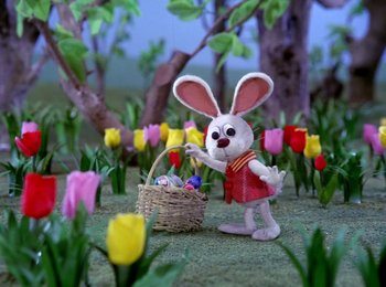 Movie still from “Here Comes Peter Cottontail” (1971), directed by Jules Bass – An easter bunny with a basket full of eggs; Wide shot, High angle