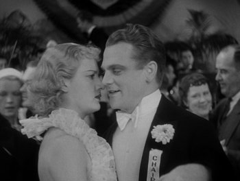Movie still from “Here Comes the Navy” (1934), directed by Lloyd Bacon – A man and a woman in formal wear kissing; Close Up shot, Low angle
