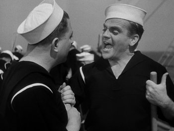 Movie still from “Here Comes the Navy” (1934), directed by Lloyd Bacon – Two men in sailor's hats are laughing together; Medium shot, Low angle