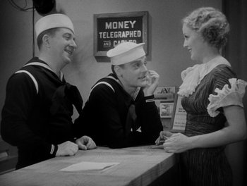 Movie still from “Here Comes the Navy” (1934), directed by Lloyd Bacon – Three sailors are sitting at a counter talking to a woman; Medium shot, Low angle