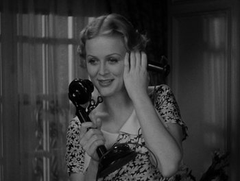 Movie still from “Here Comes the Navy” (1934), directed by Lloyd Bacon – A woman holding a phone up to her ear; Close Up shot, High angle