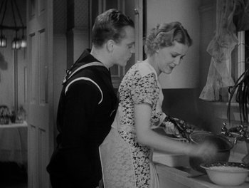 Movie still from “Here Comes the Navy” (1934), directed by Lloyd Bacon – A man and a woman in the kitchen preparing a meal; Medium shot, High angle