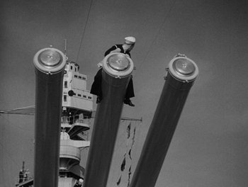 Movie still from “Here Comes the Navy” (1934), directed by Lloyd Bacon – A man standing on top of a tall building; Wide shot, Low angle