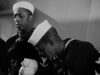Movie still from “Here Comes the Navy” (1934), directed by Lloyd Bacon – Two men in navy uniforms standing next to each other; Medium shot, Low angle