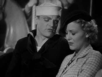 Movie still from “Here Comes the Navy” (1934), directed by Lloyd Bacon – An old photo of a man and a woman; Close Up shot, Low angle