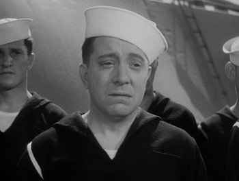 Movie still from “Here Comes the Navy” (1934), directed by Lloyd Bacon – An old photo of a sailor with a sad look on his face; Close Up shot, Low angle