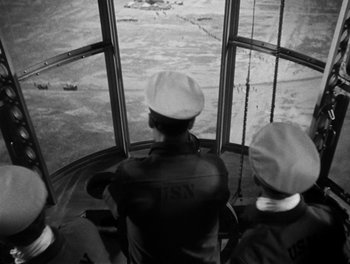 Movie still from “Here Comes the Navy” (1934), directed by Lloyd Bacon – A group of men sitting on top of a boat; Extreme Wide shot, High angle