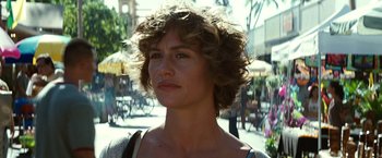 Movie still from “Hereafter” (2010), directed by Clint Eastwood – A person with curly hair on a city street; Close Up shot, Over the shoulder angle