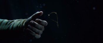 Movie still from “Hereafter” (2010), directed by Clint Eastwood – A hand is reaching out to catch a string of beads; Extreme Close Up shot, Overhead angle