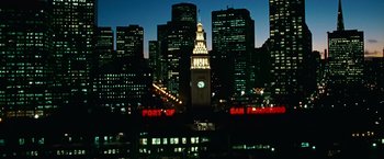 Movie still from “Hereafter” (2010), directed by Clint Eastwood – A view of a city skyline at night with a clock tower lit up at night; Extreme Wide shot, Low angle