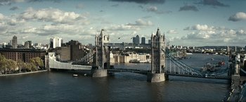 Movie still from “Hereafter” (2010), directed by Clint Eastwood – A view of a bridge that is going over a river; Extreme Wide shot, High angle