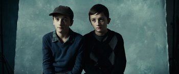 Movie still from “Hereafter” (2010), directed by Clint Eastwood – Two young men sitting next to each other; Close Up shot, High angle