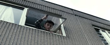 Movie still from “Hereafter” (2010), directed by Clint Eastwood – A young boy looking out of a window; Medium shot, Low angle